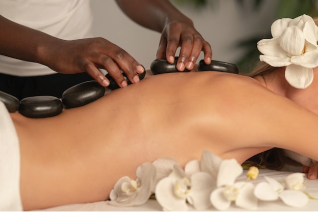 A woman getting a hot stone massage service in Las Vegas
