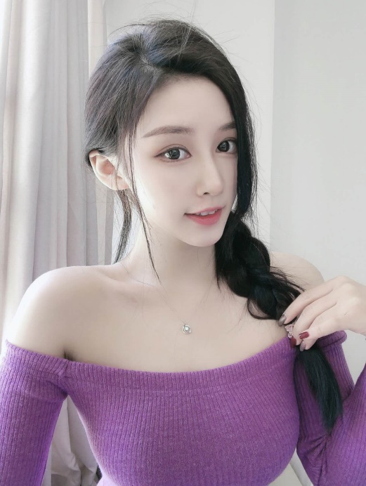 A girl in a purple top.