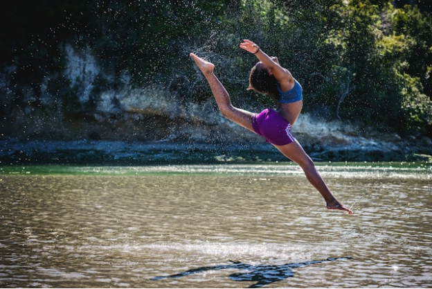 A woman dancing in the water with more flexibility 