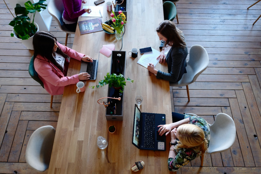 A group of employees working in a well-lit room