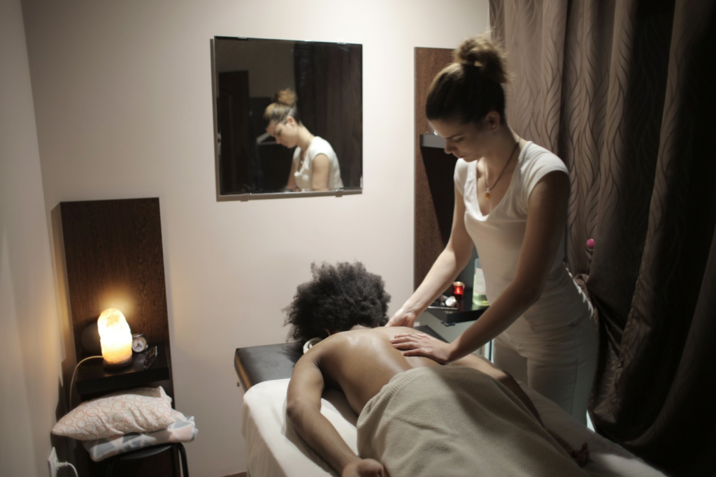 A masseuse giving back massage to a client
