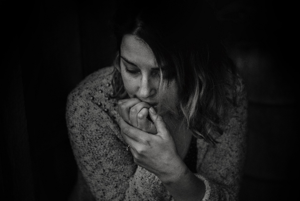  A woman biting her nails out of stress
