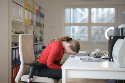 a woman sitting on her chair leaning on her laptop