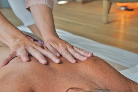  a woman giving a man a massage 