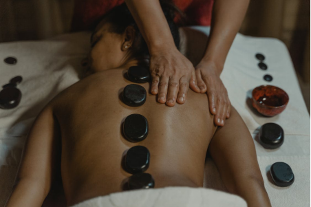 a person getting a hot stone massage 