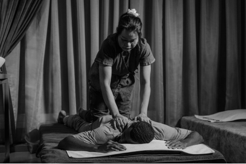  a masseuse giving a sports massage 