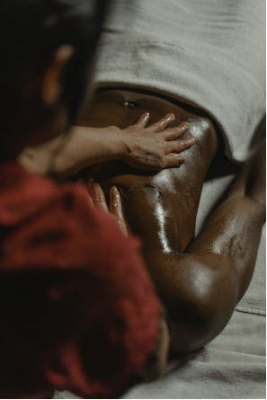 an Asian woman giving a man a massage 
