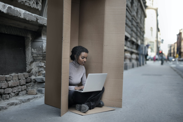 An introverted girl sitting inside a cardboard box