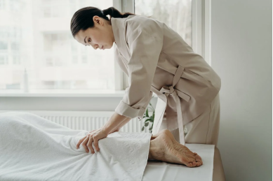 An image of a woman massaging a man’s legs 