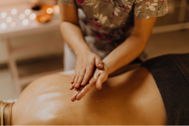 A massage therapist using oil