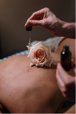 A massage therapist using oil