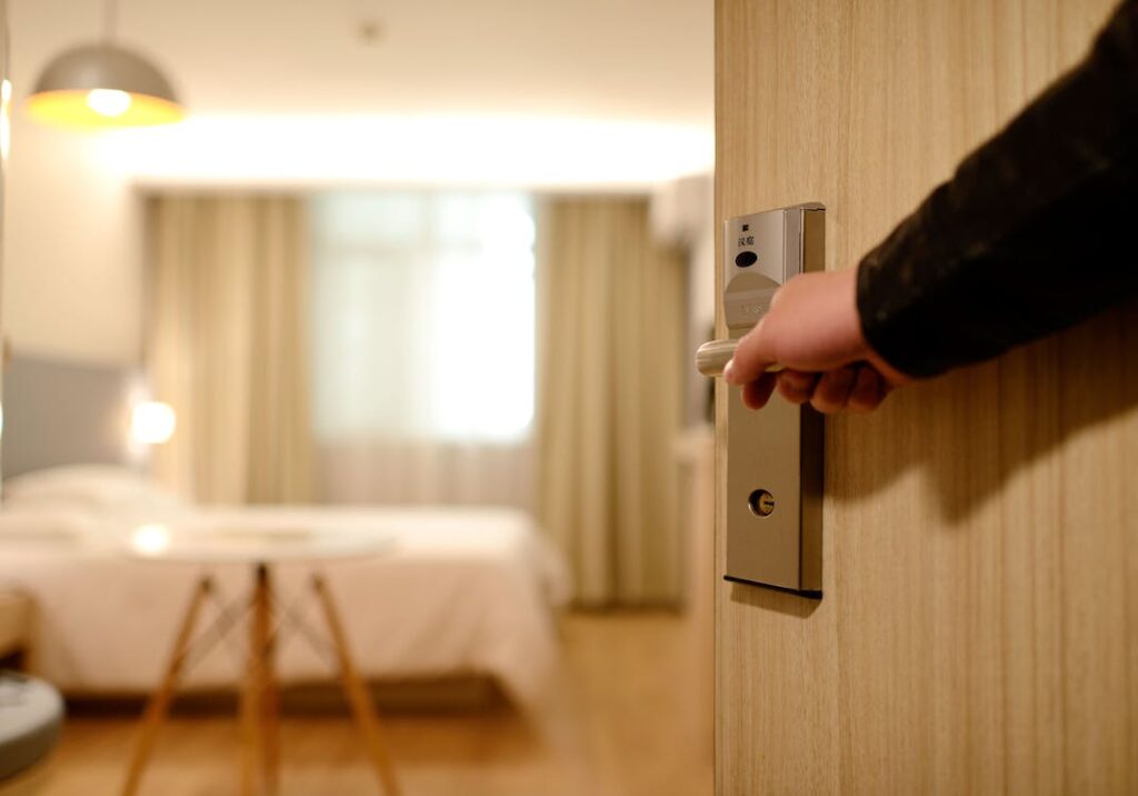 Person holding a door lever inside a room