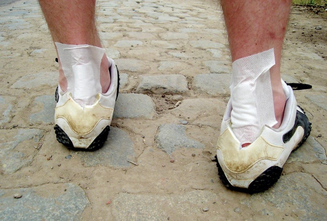 Person with a plaster on their heel, indicating tissue injury
